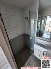 Modern bathroom with walk-in shower and vanity sink