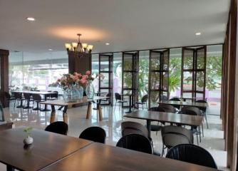 Spacious dining area with large windows and modern furnishings