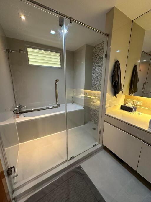 Modern bathroom with glass shower enclosure and bathtub