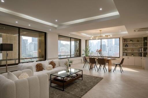 Spacious living room with dining area, large windows, and city view