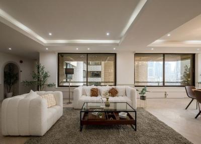 Spacious and well-lit living room with modern furniture and city view