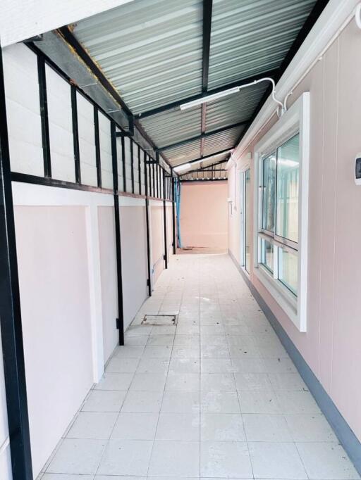 Spacious corridor with tiled flooring and large windows