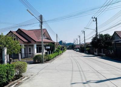 Quiet residential street with houses and clear blue sky