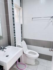 Modern tiled bathroom with white fixtures