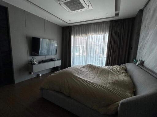 Modern bedroom with large bed and television setup