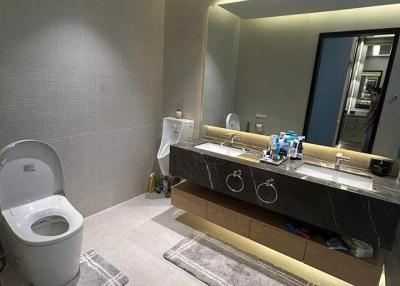 Modern bathroom with large mirror and under-sink lighting
