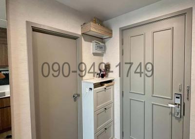 Modern entryway with white doors and storage cabinet