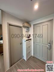 Modern entryway with white doors and storage cabinet