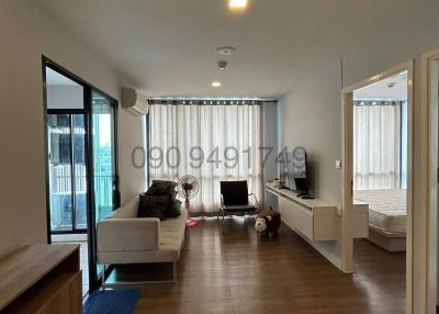 Spacious and well-lit living room with modern furniture and balcony access
