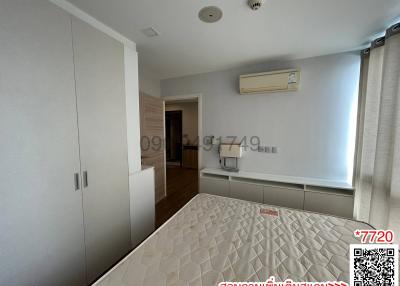 Spacious bedroom with modern wardrobe and air conditioning unit