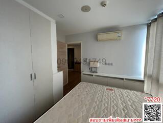 Spacious bedroom with modern wardrobe and air conditioning unit