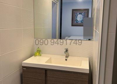 Modern bathroom with wooden cabinet and large mirror