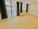 Spacious unfurnished bedroom with large windows and abundant natural light
