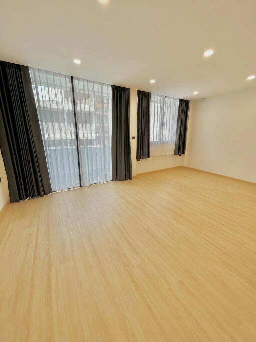 Spacious unfurnished bedroom with large windows and abundant natural light