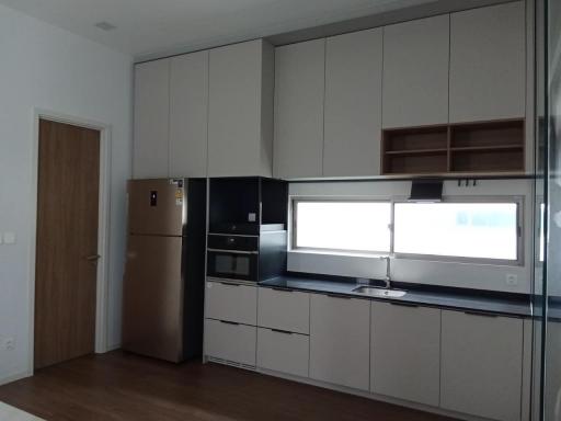 Modern kitchen with wooden floor and built-in appliances