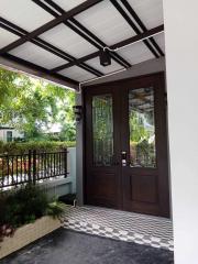 Elegant house entrance with double doors and patterned floor