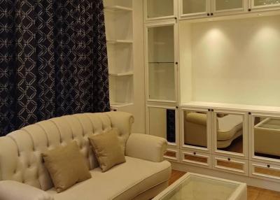 Elegant living room with beige sofa and built-in white shelves