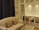Elegant living room with beige sofa and built-in white shelves