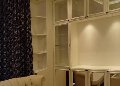 Elegant living room with beige sofa and built-in shelves