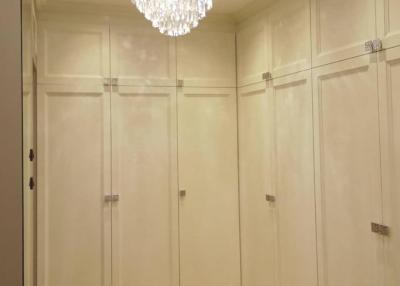 Elegant hallway with chandelier and built-in wardrobes