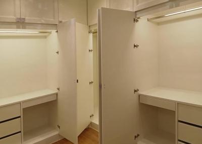 Spacious walk-in closet with ample shelving and storage space