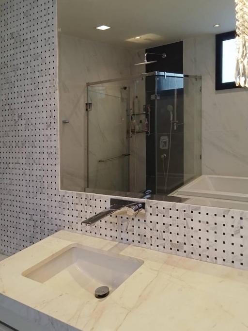 Modern bathroom with marble finishes and glass shower
