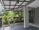 Modern house entryway with covered porch and garden view