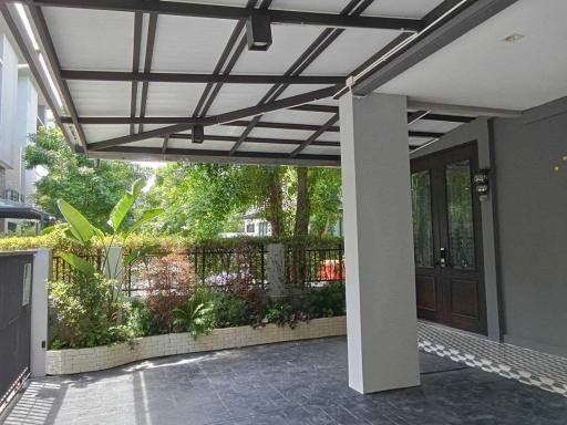 Modern house entryway with covered porch and garden view