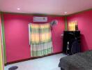 Bright pink bedroom with air conditioning and vibrant curtains