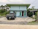 Light blue single-story house with a car parked in front