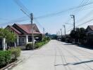 Suburban street with houses and clear blue sky