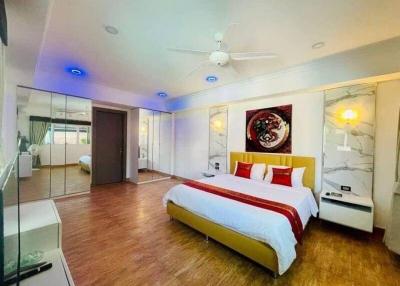 Spacious and well-lit bedroom with modern furnishings and en-suite bathroom
