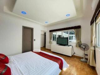 Spacious bedroom with modern amenities and ample natural light