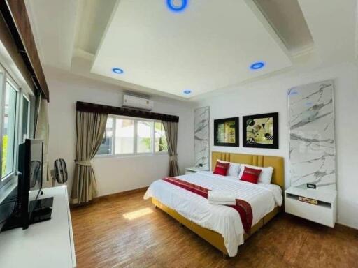 Modern bedroom with ample lighting and contemporary design