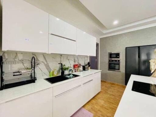 Modern kitchen with white cabinetry and built-in appliances