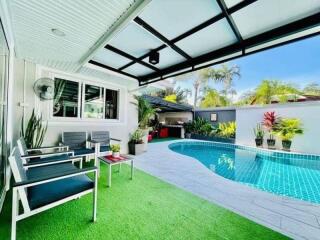 Cozy outdoor living space with pool and seating area