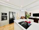 Modern kitchen with stainless steel appliances and open concept living area