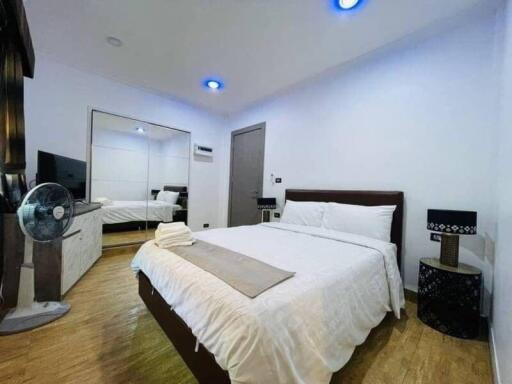 Spacious bedroom with modern decor and ample lighting