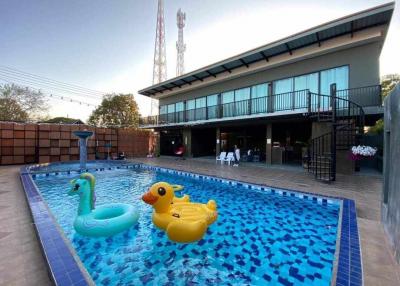 Modern house exterior with swimming pool and inflatable toys