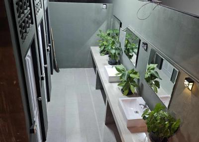 Modern building balcony with green plants and outdoor sink