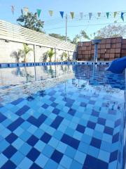 Residential swimming pool with blue tiles and festive decorations