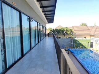 Spacious balcony with pool view in residential property