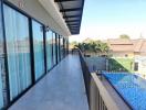 Spacious balcony with pool view in residential property