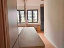 Modern hallway with reflective surfaces and ample natural light