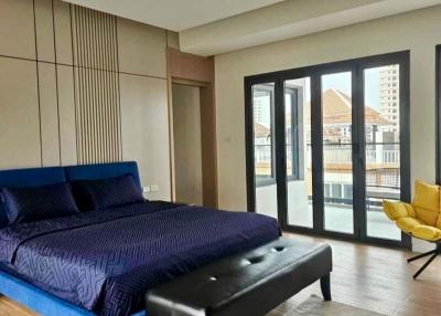 Modern bedroom with large bed and balcony access