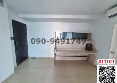 Spacious unfurnished living room with large window and hardwood flooring