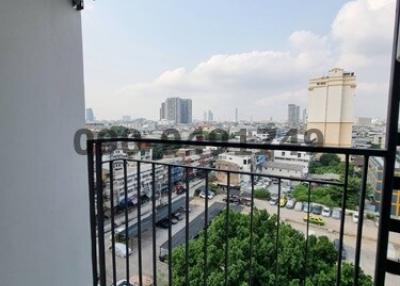 City view from high-rise apartment balcony with clear railings and tiled floor