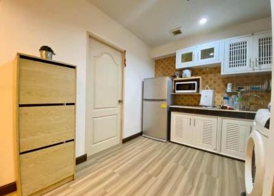 Compact kitchen with fitted appliances and wooden floor