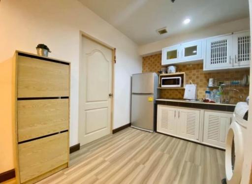 Compact kitchen with fitted appliances and wooden floor