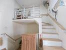 Bright staircase area with under-stairs storage and metal railings